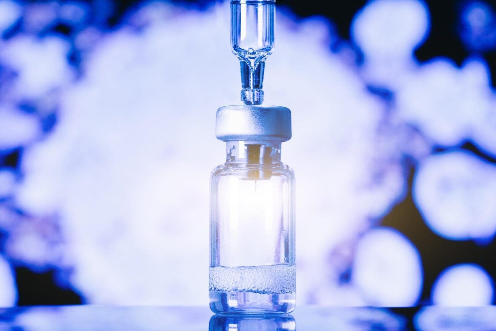 A lab technician wearing protective gloves and goggles carefully handles a test tube