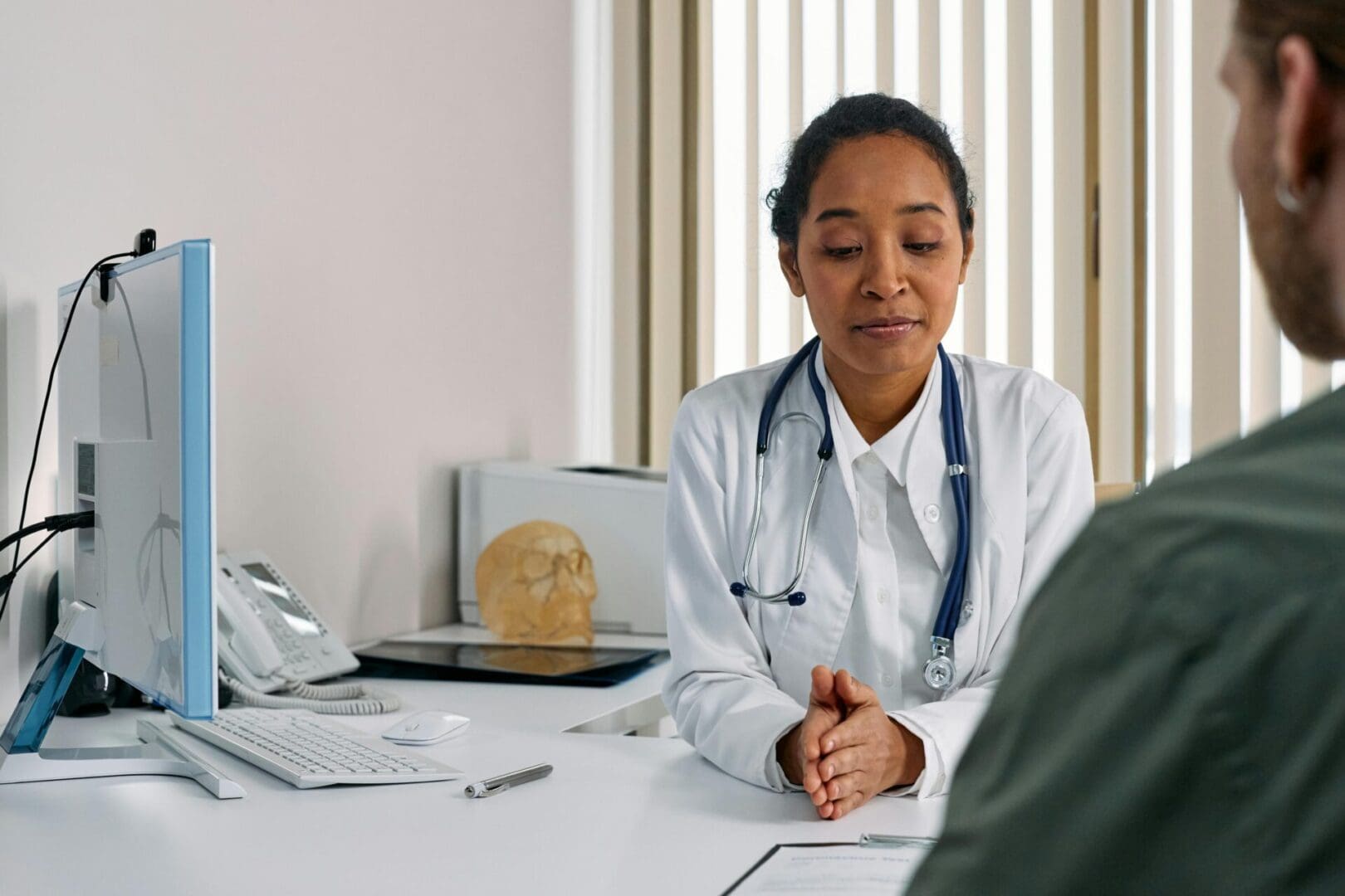 A Healthcare professional providing a medical consultation to a patient in a clinic.